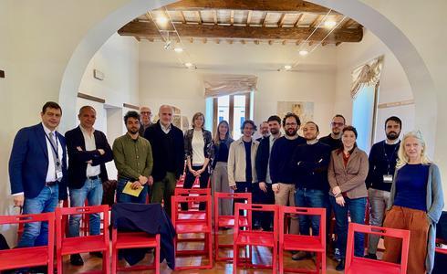 A group picture of happy-looking participants after the workshop, gathered in a small room