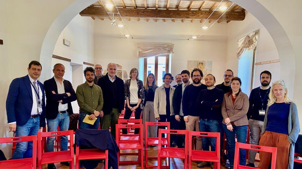 A group picture of happy-looking participants after the workshop, gathered in a small room